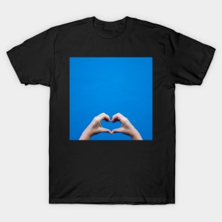 Love sign made by hands against a blue wall T-Shirt